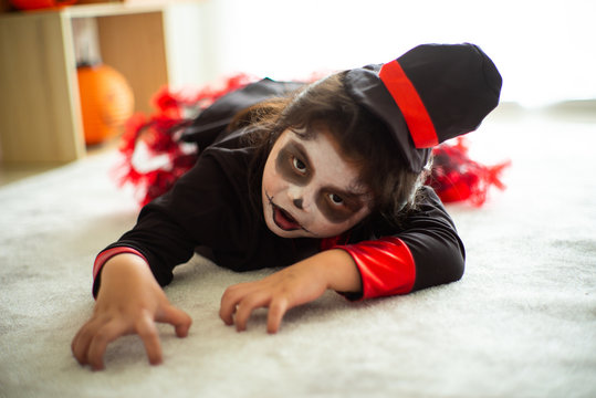 Portrait Asian little girl in Halloween costume acting scary and frightening expression for Halloween festival