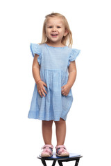 cute little girl in blue dress is laughing