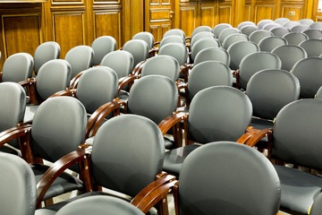 Black modern seats armchairs in conference room. Interior of conference or business hall