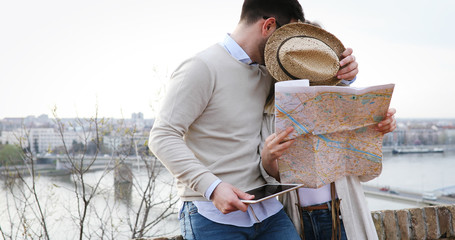 Couple of tourists looking at city tour map