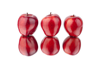 Three red apples with mirror reflection white background isolated close up