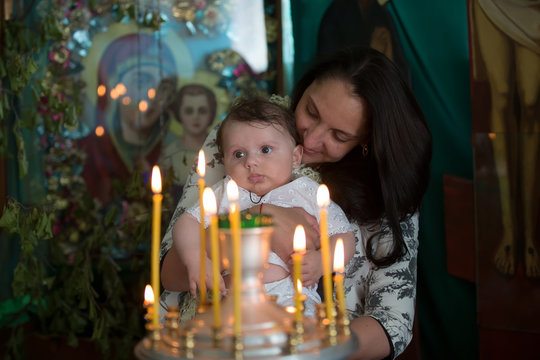 Mother And Child In Church Looking At Candles