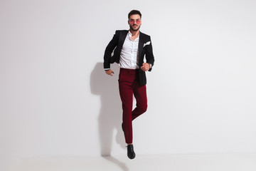 elegant man jumping in the air and posing like running