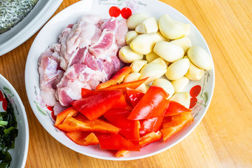 a plate of chopped pork belly and garlic