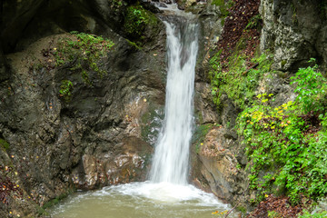 Fototapeta na wymiar An impressive waterfall in a gorge in Austria