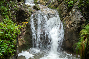 Fototapeta na wymiar An impressive waterfall in a gorge in Austria