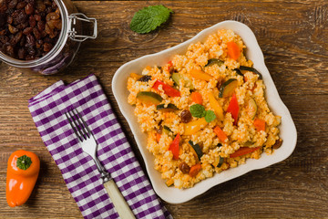 Millet with vegetables and raisins.