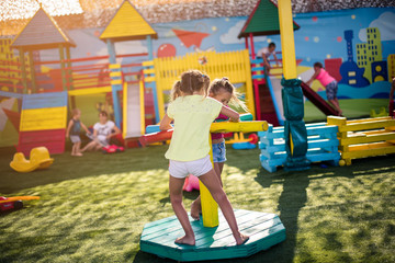 Fototapeta na wymiar Active little girl on playground.