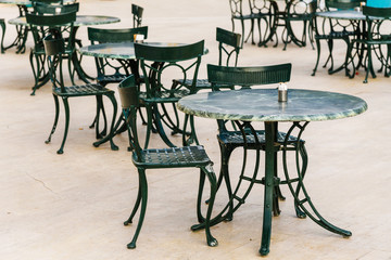 Fototapeta na wymiar Street cafes, empty tables and chairs on the street