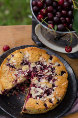Homemade cherry pie on a wooden chair in the garden