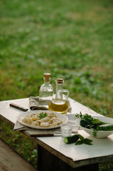 Homemade Meat Dumplings - russian pelmeni with fresh parsley on plate. Dinner outside in the garden