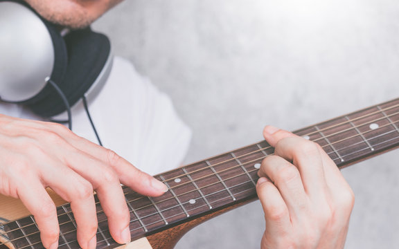 male musician hands playing acoustic guitar