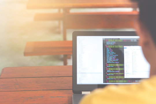 Closeup coding on screen, Young man programming on a laptop, development web, developer..