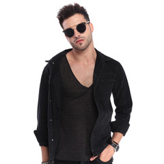 portrait of relaxed bad boy wearing sunglasses and black clothes