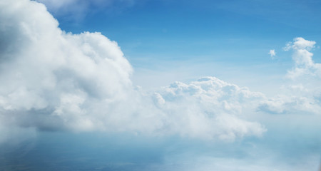 Blue sky and clouds background with lots of copy space.