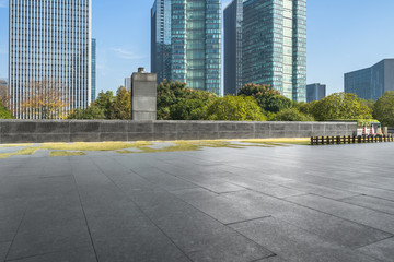 empty pavement and modern buildings in city.