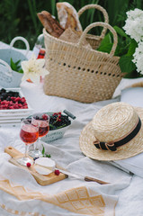 Picnic wicker basket with food on on the grass. Picnic concept.