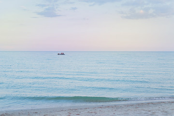 Fototapeta premium Lonely sailboat in the open sea at sunset.