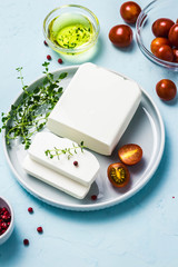 Feta cheese with herbs and olive oil. Top view, space for text.