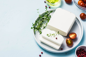 Feta cheese with herbs and olive oil. Top view, space for text.