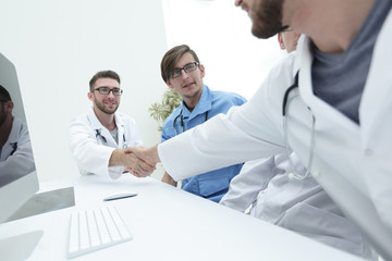 Fototapeta na wymiar handshake between the two doctors during the working meeting