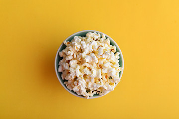 Popcorn in a bowl on yellow