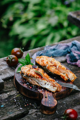 Grilled salmon on a wooden board on an old table