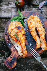 Grilled salmon on a wooden board on an old table