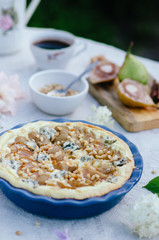 Pie whith pears, pine nuts and blue cheese in ceramic form, very delicious and tasty cake.