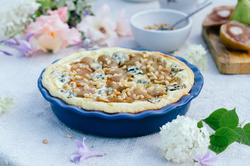 Pie whith pears, pine nuts and blue cheese in ceramic form, very delicious and tasty cake.