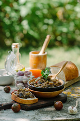 Traditional Caucasian saute from stewed eggplants, peppers, onions, tomatoes and herbs on the old background in rustic style