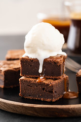 Chocolate brownies with salted caramel, vanilla ice cream. Copy space.