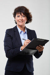 Mature businesswoman with a clipboard