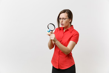 Portrait of business teacher woman in red shirt holding and looking through magnifying glass on globe isolated on white background. Education teaching in high school university concept. Copy space.