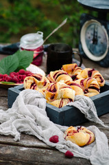 Buns with raspberries and powdered sugar in rustic style