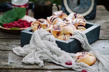 Buns with raspberries and powdered sugar in rustic style
