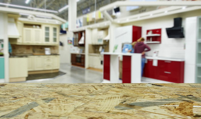 Defocused, blurred image of the department of kitchen furniture sets.