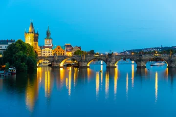 Deurstickers Illuminated Charles Bridge reflected in Vltava River. Evening in Prague, Czech Republic. © pyty