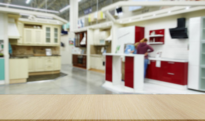 Defocused, blurred image of the department of kitchen furniture sets.