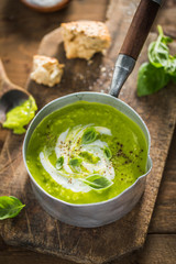 Green pea creamy soup in pot