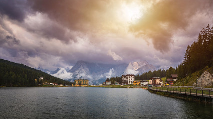 Naklejka na ściany i meble Misurina Lake in the Dolomites mountains in Italy near Auronzo di Cadore on a cloudy day, Sorapiss mountain in the background. South Tyrol, Dolomites, Italy.