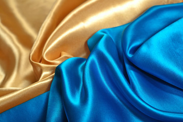 Natural golden and blue satin fabric texture