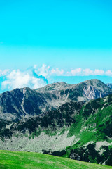 Beautiful alpine high mountains peaks, blue sky background. Amazing Mountain hiking paradise landscape, summertime.