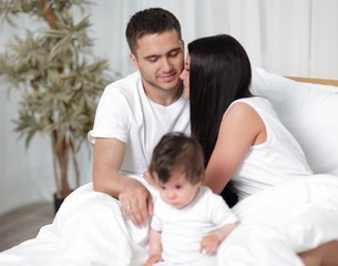 Obraz premium A happy young family from three persons