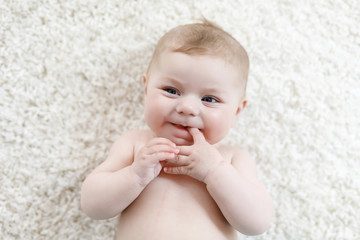 Adorable naked baby girl on white background. © Irina Schmidt