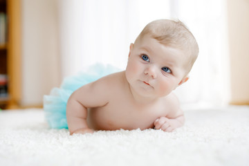 Adorable baby girl on white background wearing turquoise tutu skirt. © Irina Schmidt