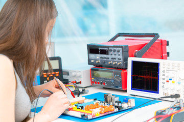 Girl schoolgirl in the classroom in the laboratory of robotics and electronics