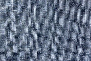Old blue denim jeans texture or background with visible fibers 