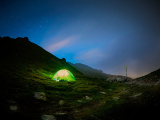 Tent in Saua Caprei, Fagaras mountains, Romania during the night, long exposure
