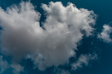 A big cloud in the blue sky.